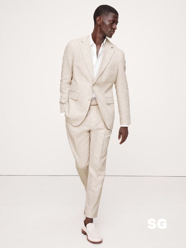 man wearing a summer weight suit in a light color with loafers